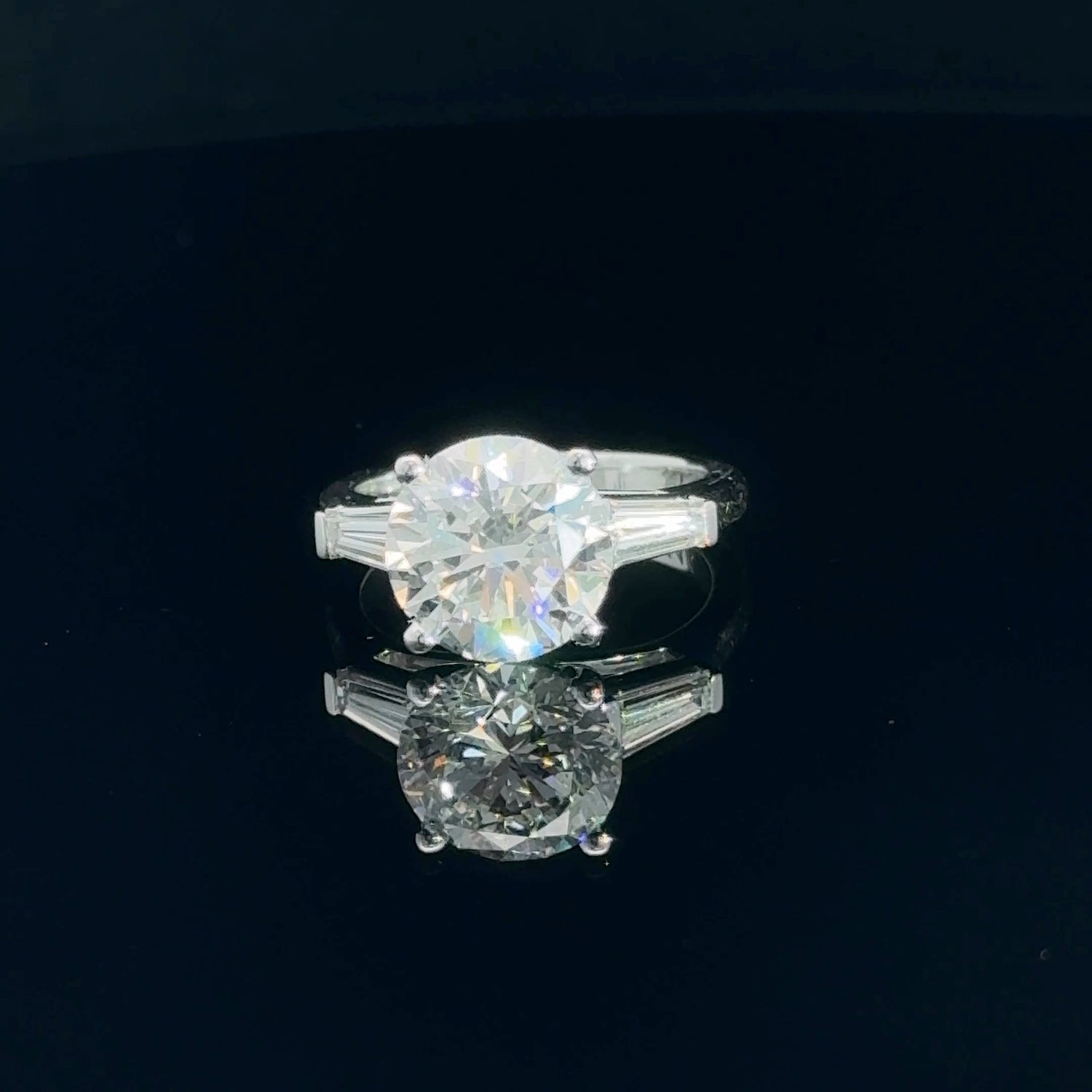 14K white gold engagement ring with a 3.75 carat round brilliant lab grown diamond and tapered baguette side stones